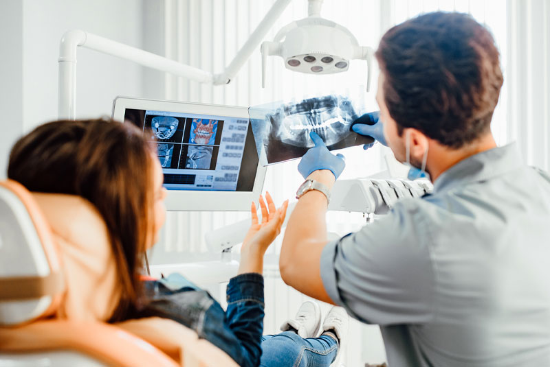 dentist going over medical emergency with patient