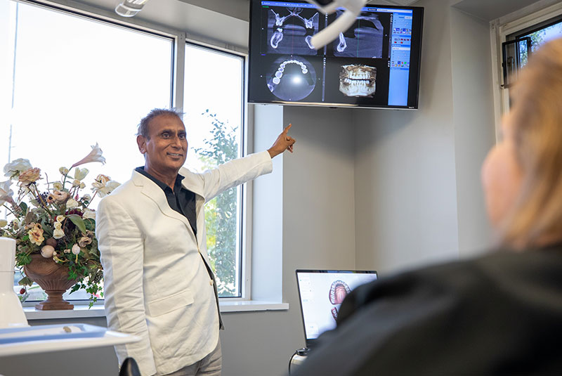 doctor showing patient dental procedure information within the dental center