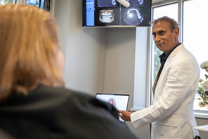 patient going over dental procedure information with patient within the dental center